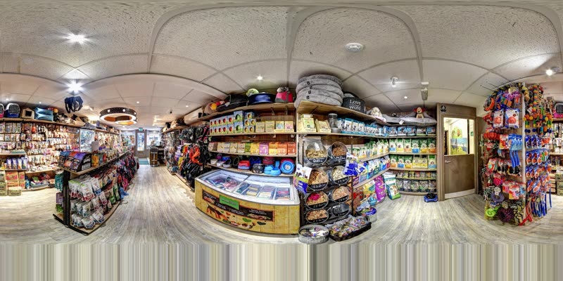 Inside the shop, with aisles of pet food and accessories and the central counter